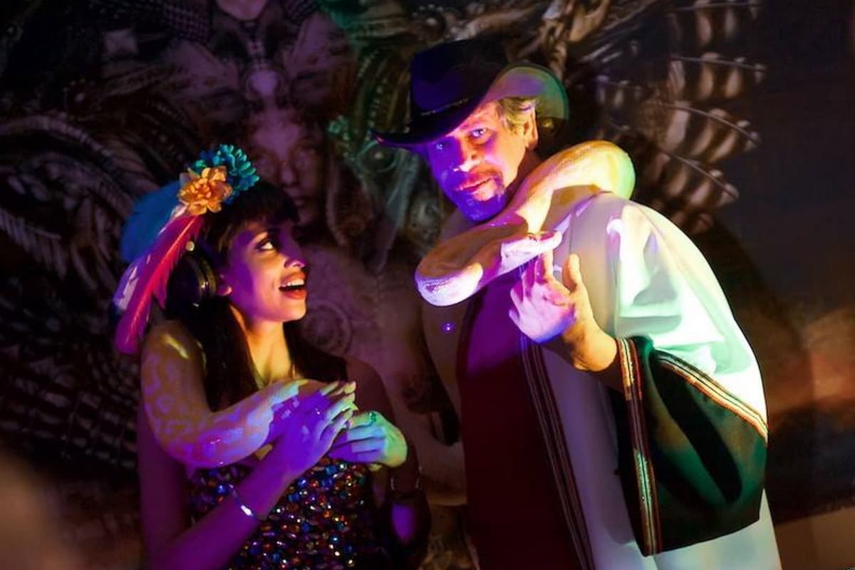 Daryl Sprout performing with snakes in theatrical setting